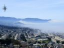 Fog in Pacifica California, fog moving in from ocean, Highway 1 at bottom right of photo, part of Montara Mountain in the distance