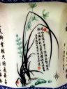 Cymbidium orchid leaves and flowers, illustrated as part of the Four Gentleman on a Chinese flower pot, Pacifica, California