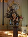 Cut flower arrangement with Cymbidium orchids in vase on pedestal, Filoli Orchid Show, Filoli Historic House and Garden, Woodside, California