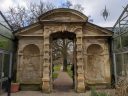 Garden doorway between glasshouses at University of Oxford Botanic Garden, Oxford, Oxfordshire, England, UK